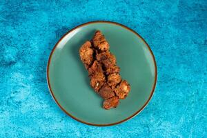 spicy bbq chicken tikka boti kabab served in a dish isolated on background top view photo