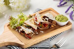 LE SPECIAL Shawarma wraps with salad and sauce served in a cutting board isolated on table side view of arabian food photo