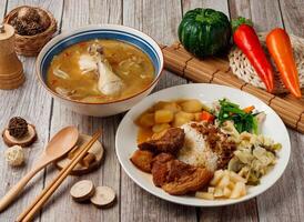 Assorted Ancient Taste Knuckle Rice, Sesame Oil Chicken Soup served in dish isolated on table top view of taiwan food photo