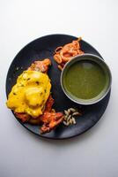 Spicy nawabi tandoori chicken with cheese and chili sauce served in a dish isolated on grey background top view of bangladesh food photo