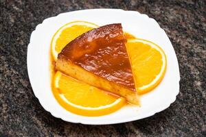 Caramel pudding with lemon slice served in dish isolated on background top view of bangladesh and indian food photo