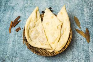 Plain Naan served in a dish isolated on grey background top view of bangladesh food photo