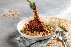 Lamb Shank biryani rice served in dish isolated on table top view of arabic breakfast photo