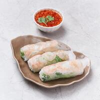 Fresh Spring Rolls with chili sauce served in a dish isolated on grey background side view of vietnam food photo