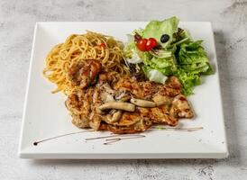 mushroom grill chicken with aglio pasta and salad served in dish isolated grey background top view singapore fast food photo