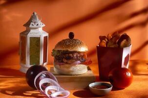 BBQ chicken cheese burger with french fries, potato and tomato slice isolated on wooden board side view on table fast food photo