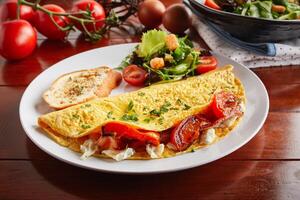 Greek Style cream sauce omelette roll with salad served in a dish isolated on wooden background side view photo