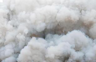 Mysterious White Smoke Swirls Amidst Billowing Black Clouds from Ignition Source. photo