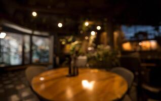 Cozy Cafe Ambiance, Empty Wooden Table with Golden Bokeh on Dark Background. photo