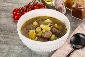 Soup with meatball and potato photo