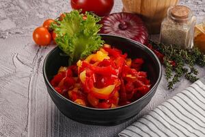 Diced raw bell red and yellow pepper photo