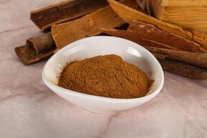 Natural Cinnamon powder with sticks photo