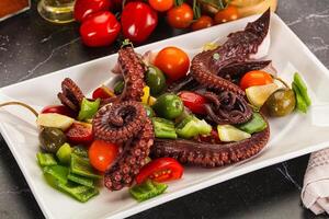 Salad with octopus tentacle and vegetables photo