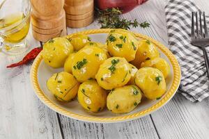 Hot boiled baby potato with oil photo