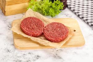 Raw beef  burger cutlet for grill photo