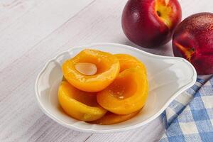 Canned peaches with sweet syrope photo