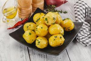 Hot boiled baby potato with oil photo