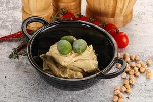 Tasty hummus with green olives photo