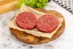 Raw beef  burger cutlet for grill photo