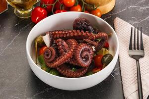 Salad with octopus tentacle and vegetables photo