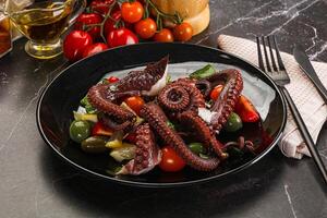 Salad with octopus tentacle and vegetables photo