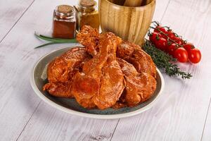 Raw turkey shoulder wing in Indian tandoori marinade photo