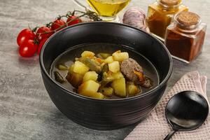 Soup with meatball and potato photo