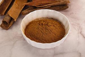 Natural Cinnamon powder with sticks photo