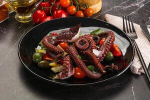 Salad with octopus tentacle and vegetables photo