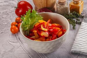 Diced raw bell red and yellow pepper photo