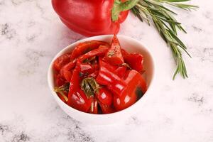 Pickled red bell pepper in the bowl photo