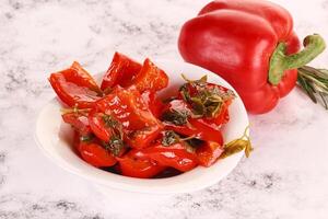 Pickled red bell pepper in the bowl photo