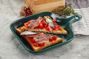 Sandwich with tomato and anchovy photo