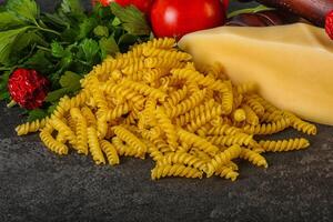 Raw Italian pasta Fusilli for cooking photo