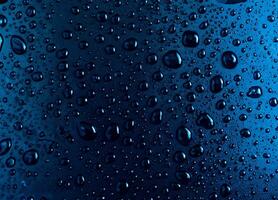 Water droplets on a background with a blue glass texture. photo