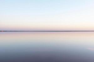 Tranquil Minimalist Landscape, Smooth Surface of Pink Salt Lake photo