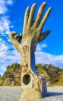 Puerto Escondido Oaxaca Mexico 2022 Hands stone rock statue sculpture beach Puerto Escondido Mexico. photo