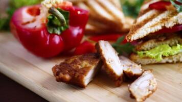 fried toast with chicken, salad, greens on a wooden table video