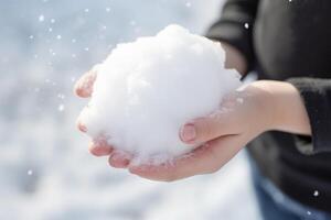 ai generado persona participación un bola de nieve en su mano en invierno. generativo ai foto