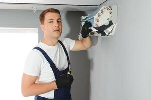 technician service checking and repairing air conditioner indoors photo