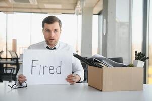 fired employee holding fired sign in hand photo