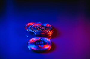 Bitcoin crypto currency illuminated by red and blue light. Blockchain technology concept used by crypto currencies like Bitcoin and Ethereum photo