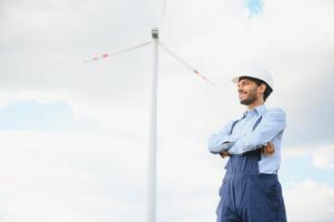 Worker inside sustainable energy industry - Engineer working at alternative renewable wind energy station photo