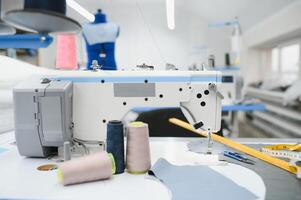 sewing supplies on the table next to the sewing machine photo