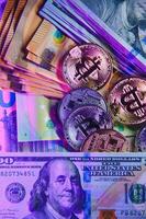 Bitcoin on background of US dollars, euro banknotes. Electronic decentralized money, exchange rate and growth of crypto currency photo