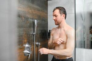 Man warming up in the shower photo