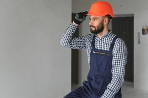 Builder handyman with construction tools. House renovation background. photo