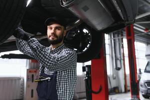 auto mecánico trabajando a auto reparar tienda foto