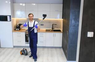 Man cleaning in the flat with vacuum cleaner photo