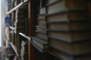 old books on shelves in archive blurred image, library photo